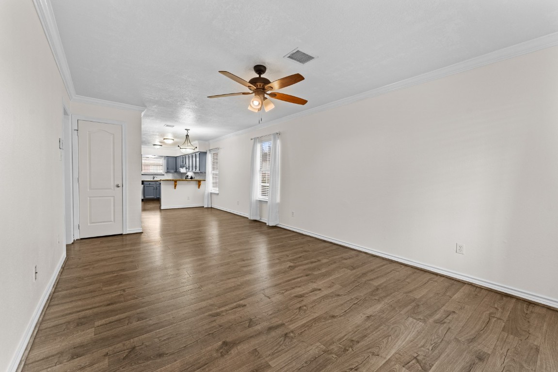 842 East 29th Street Houston, TX 77009 - Photo 4 of 24 a view of a kitchen with wooden floor and a ceiling fan