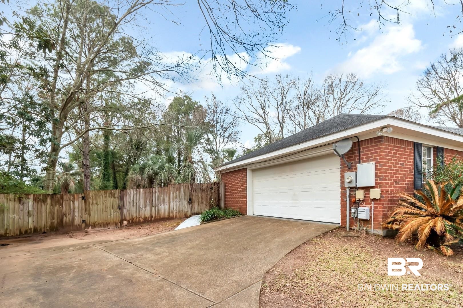 10006 Wedgefield Court Mobile, AL 36608 - Photo 6 of 34 Garage featuring concrete driveway and fence
