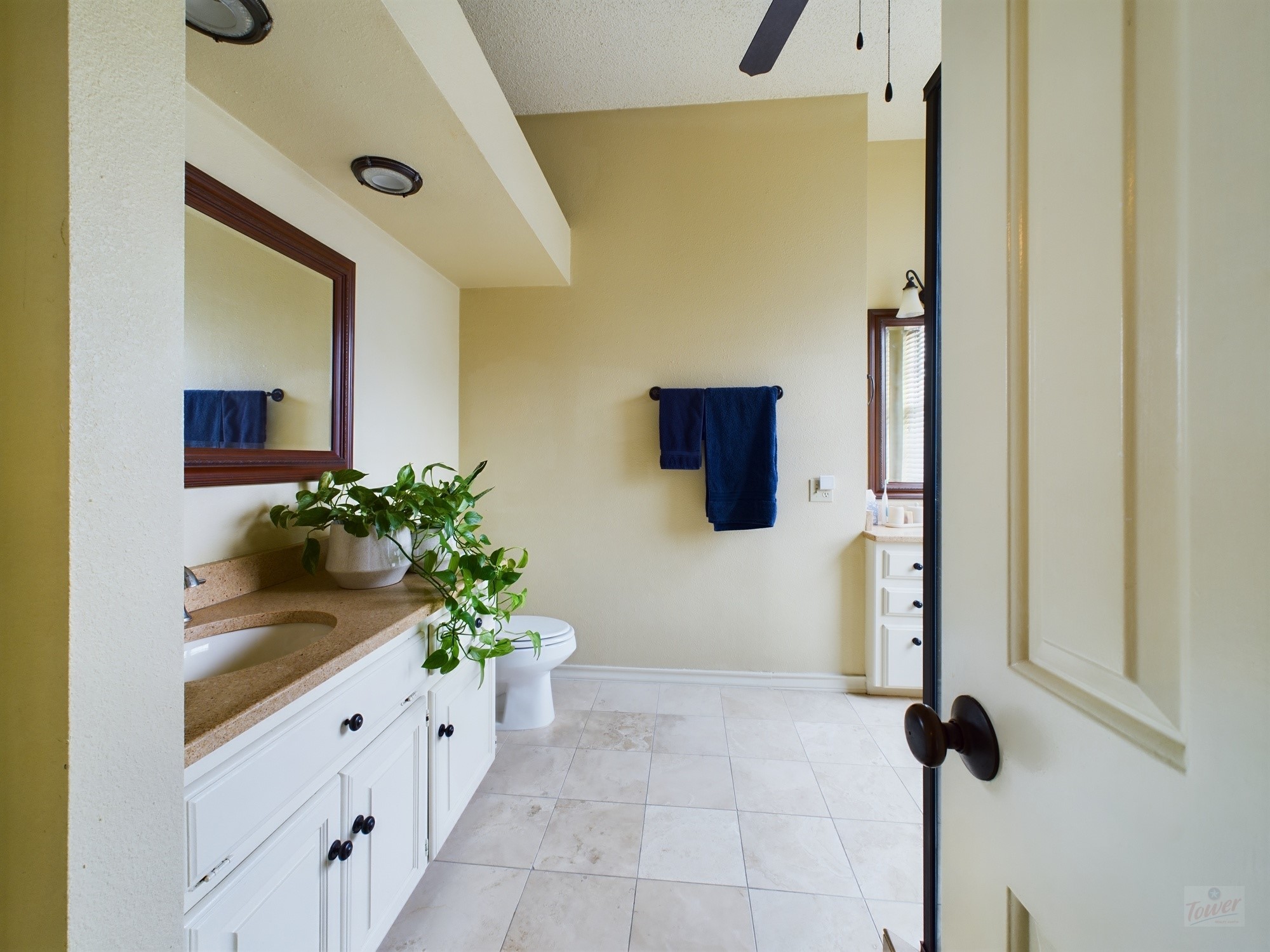 914 West 26th Street, Unit 303 Austin, TX 78705 - Photo 23 of 30 a bathroom with a granite countertop sink a mirror and shower
