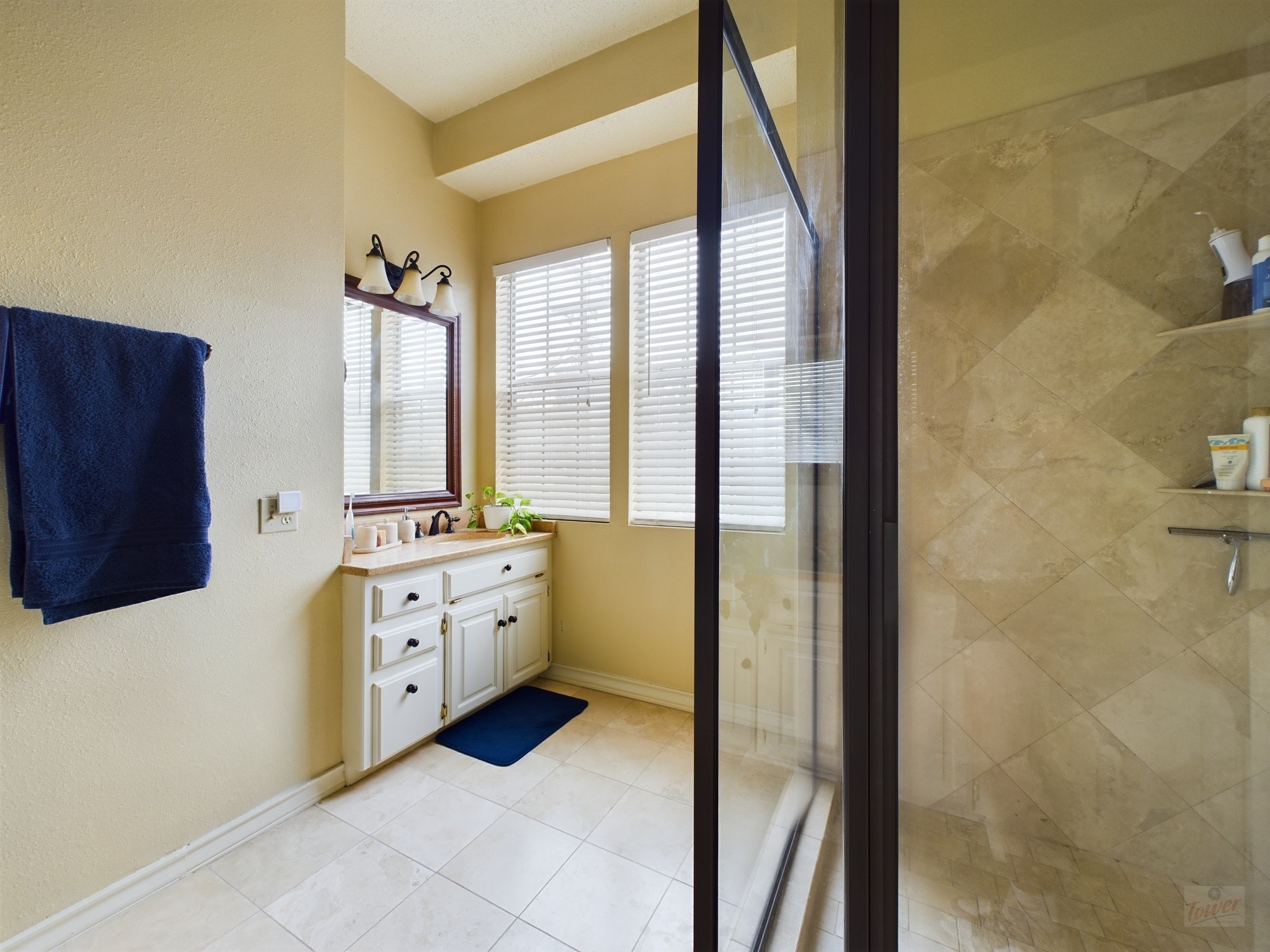 914 West 26th Street, Unit 303 Austin, TX 78705 - Photo 24 of 30 a bathroom with a double vanity sink a mirror and a bathtub
