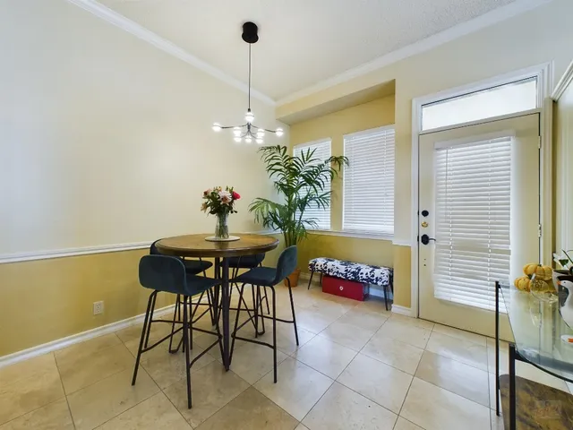 a dining room with furniture and a chandelier