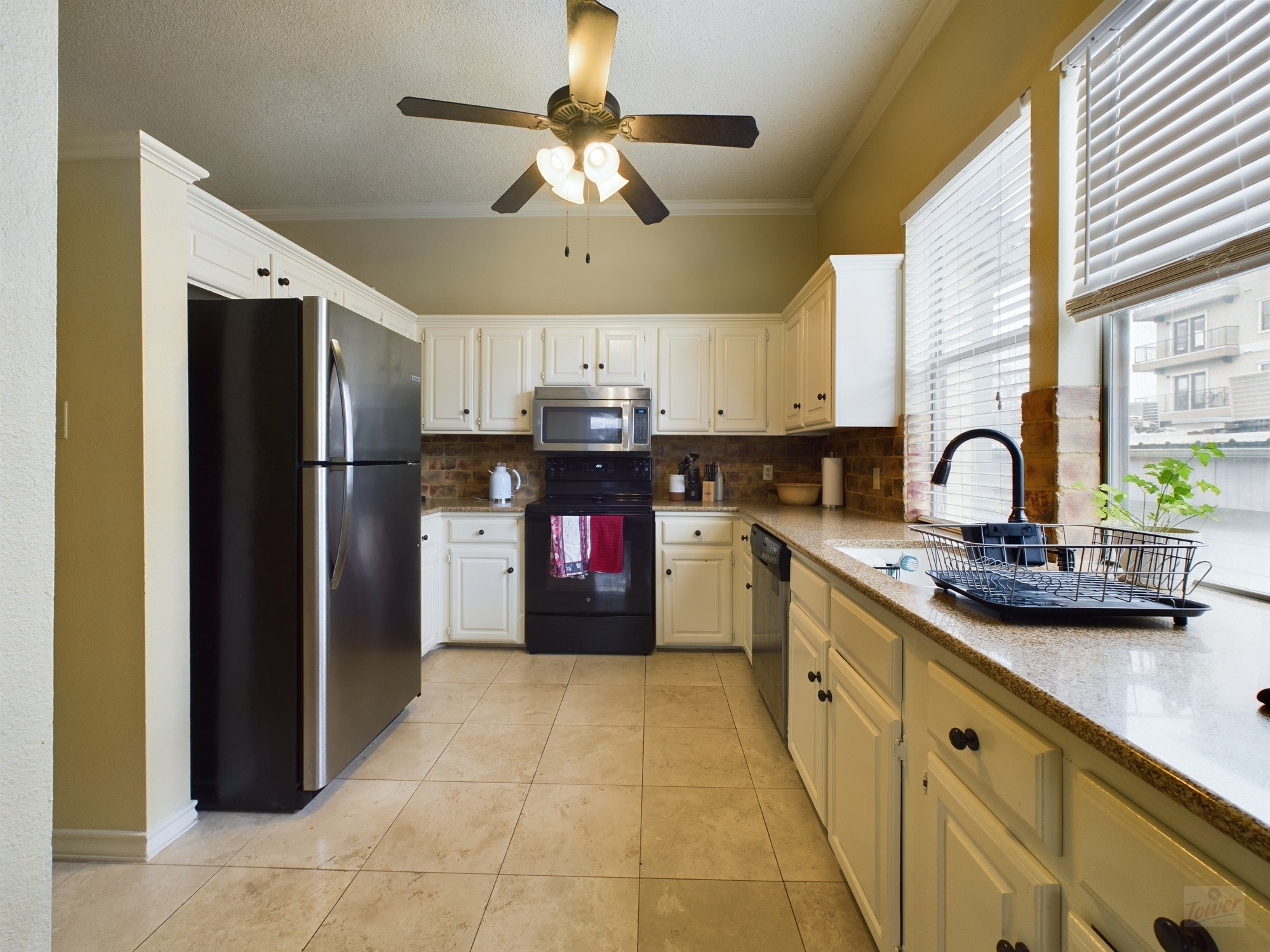 914 West 26th Street, Unit 303 Austin, TX 78705 - Photo 5 of 30 a kitchen with stainless steel appliances granite countertop a sink a stove and refrigerator