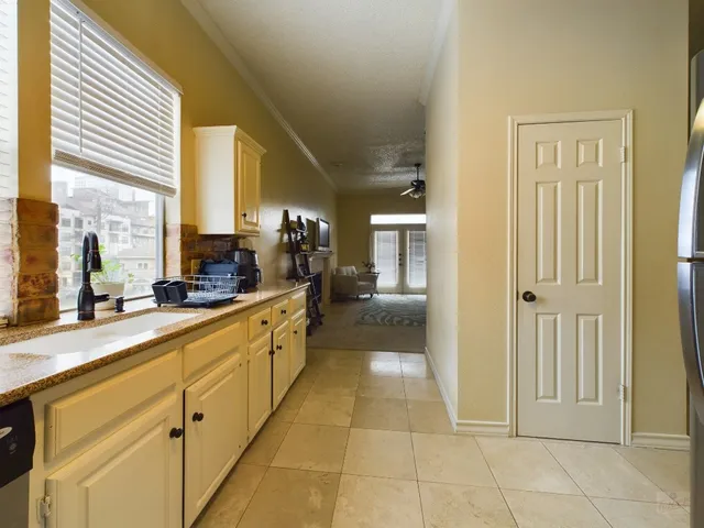 a large white kitchen with cabinets