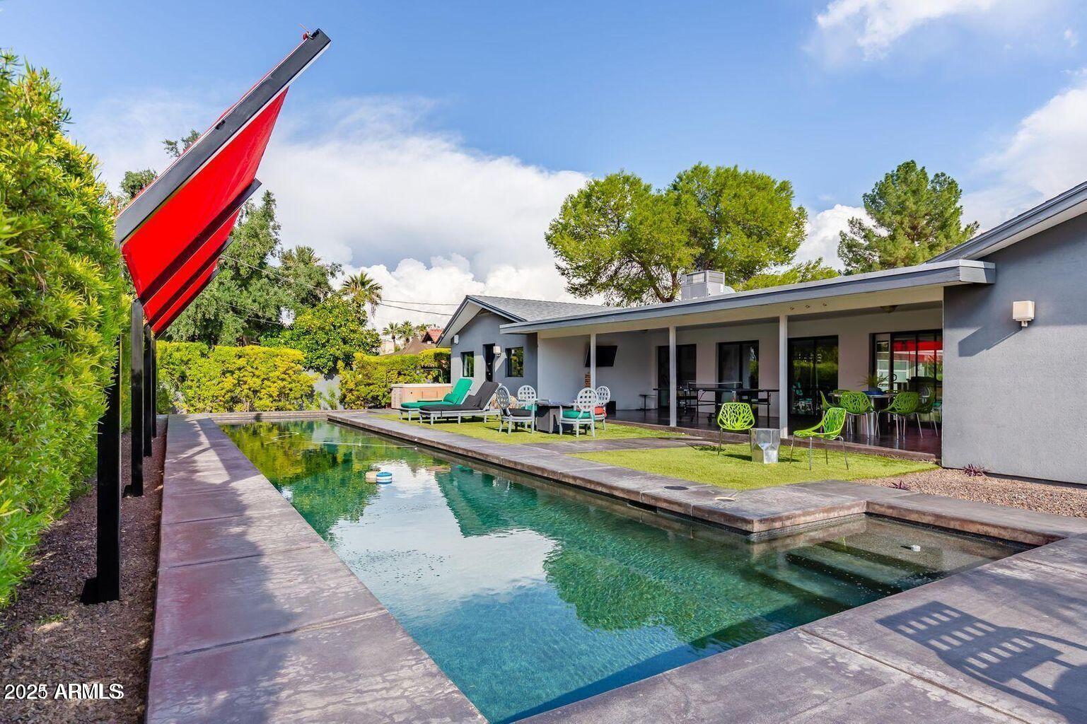 a view of house with swimming pool outdoor seating