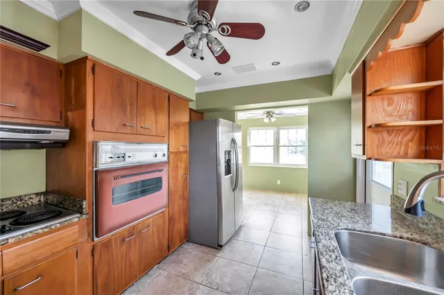 a kitchen with stainless steel appliances granite countertop a refrigerator and a sink