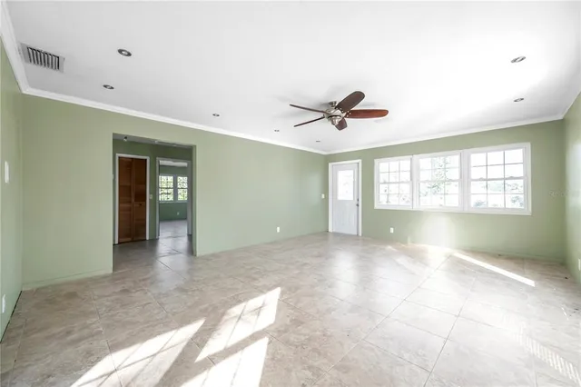 a view of livingroom with a ceiling fan and window