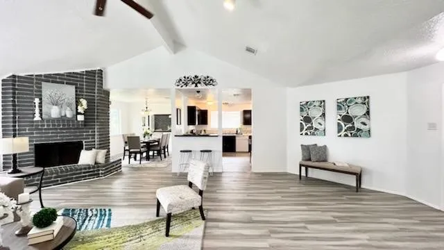 a living room with furniture fireplace and window