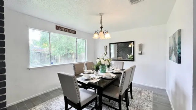 a dining room with furniture window and outside view