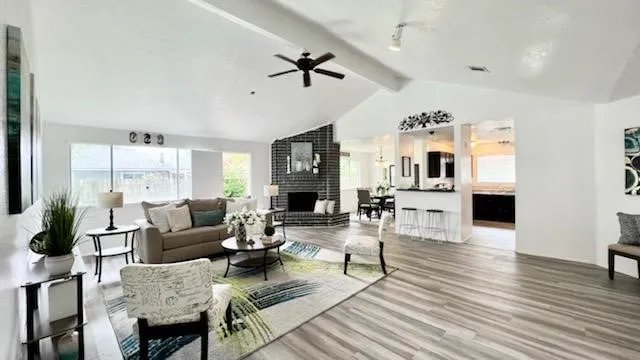 a living room with fireplace furniture and a wooden floor