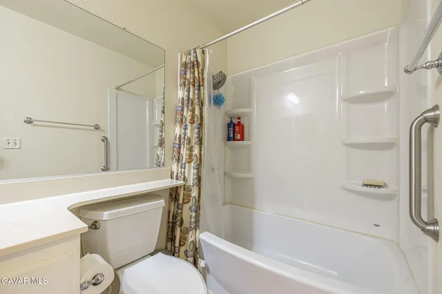 a bathroom with a shower a toilet and a shower