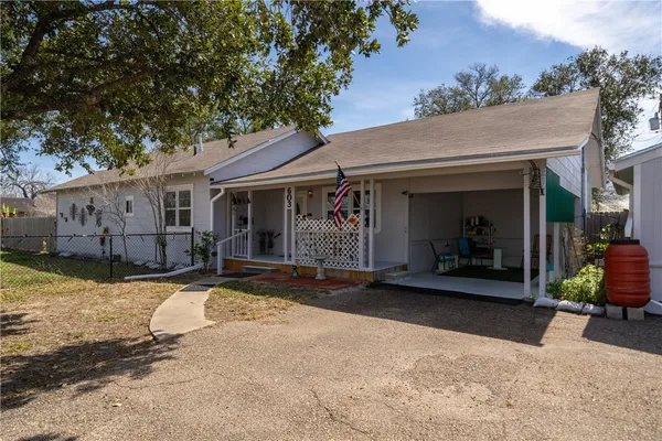 a view of a house with backyard porch and sitting area