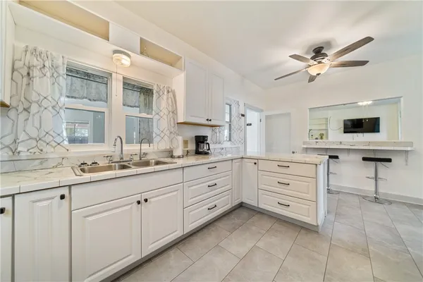 a kitchen with cabinets appliances and a window