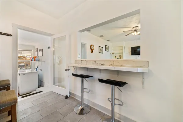 a living room with stainless steel appliances kitchen island granite countertop furniture and a view of kitchen