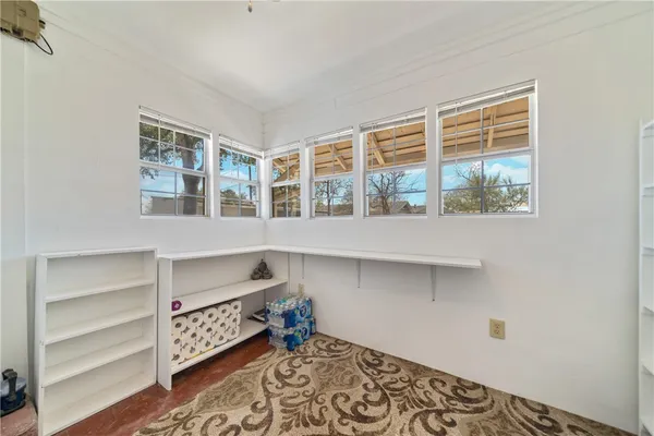 a hallway with a large window and wooden floor