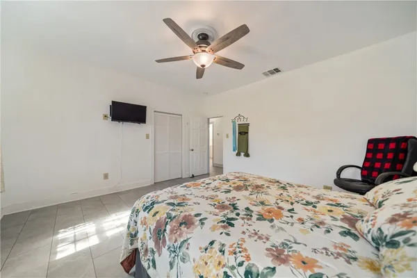 a bedroom with a bed and a ceiling fan