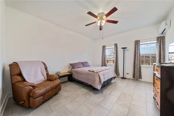 a bedroom with a bed couch and window