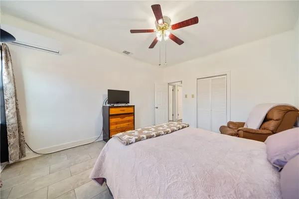 a bedroom with a bed and a chandelier