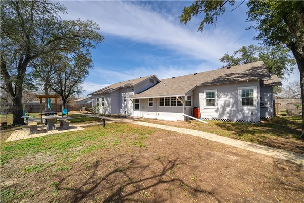 a view of a house with a yard patio and tree s