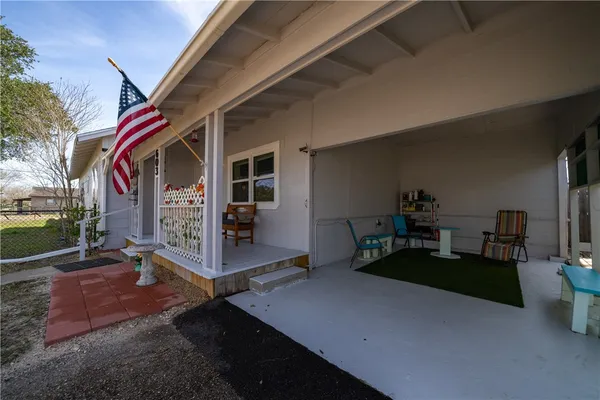 a view of outdoor kitchen with seating area
