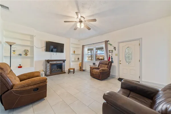 a living room with furniture and a fireplace