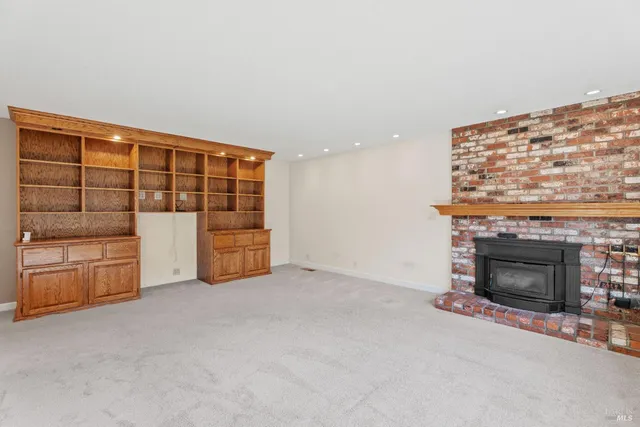 a view of an empty room with a fireplace