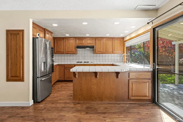 a kitchen with stainless steel appliances granite countertop a refrigerator and a sink