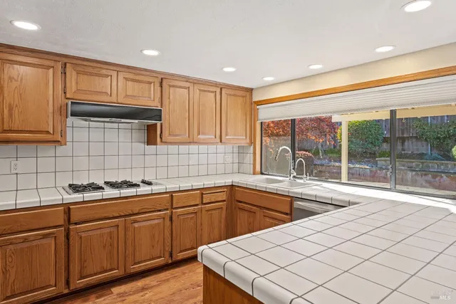 a kitchen with sink cabinets and wooden floor