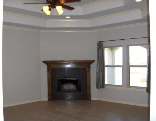 a living room with a fireplace and a chandelier