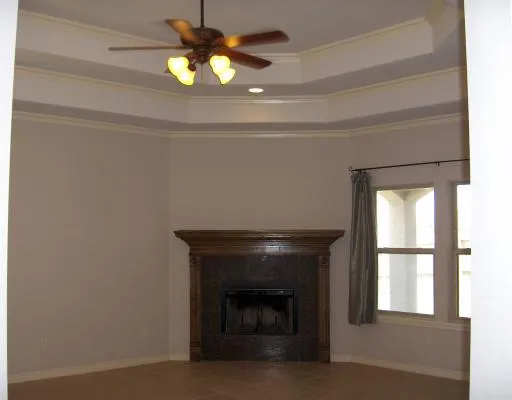 a living room with a fireplace and a window