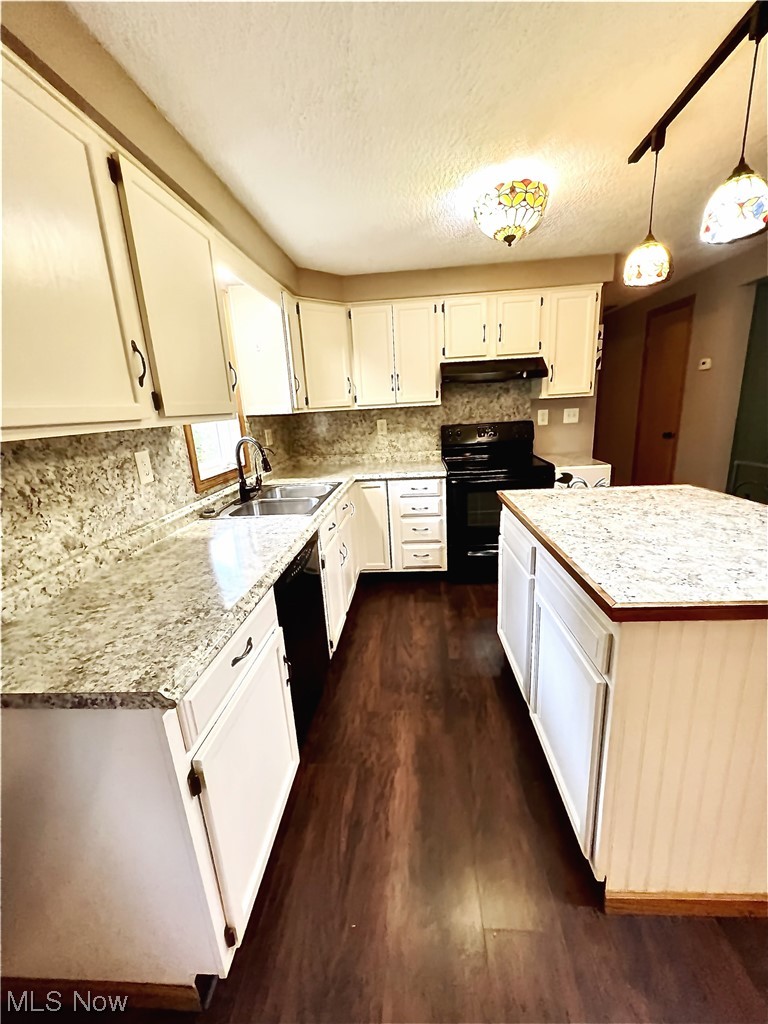 3122 Bedrock Road Northwest Dellroy, OH 44620 - Photo 12 of 23 Kitchen featuring sink, hanging light fixtures, a center island, white cabinetry, and dark hardwood / wood-style flooring