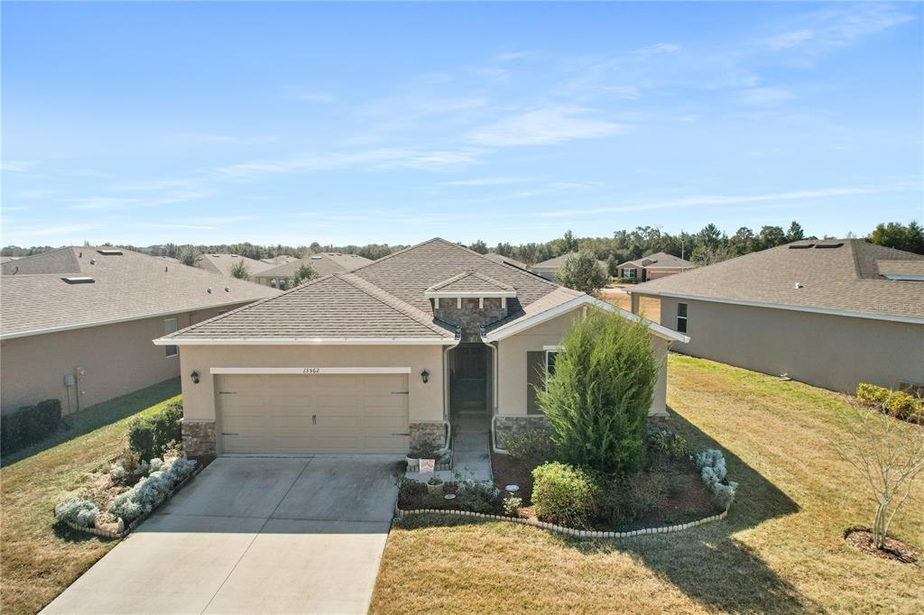 13562 Paddington Way Spring Hill, FL 34609 - Photo 1 of 1 an aerial view of a house with a yard