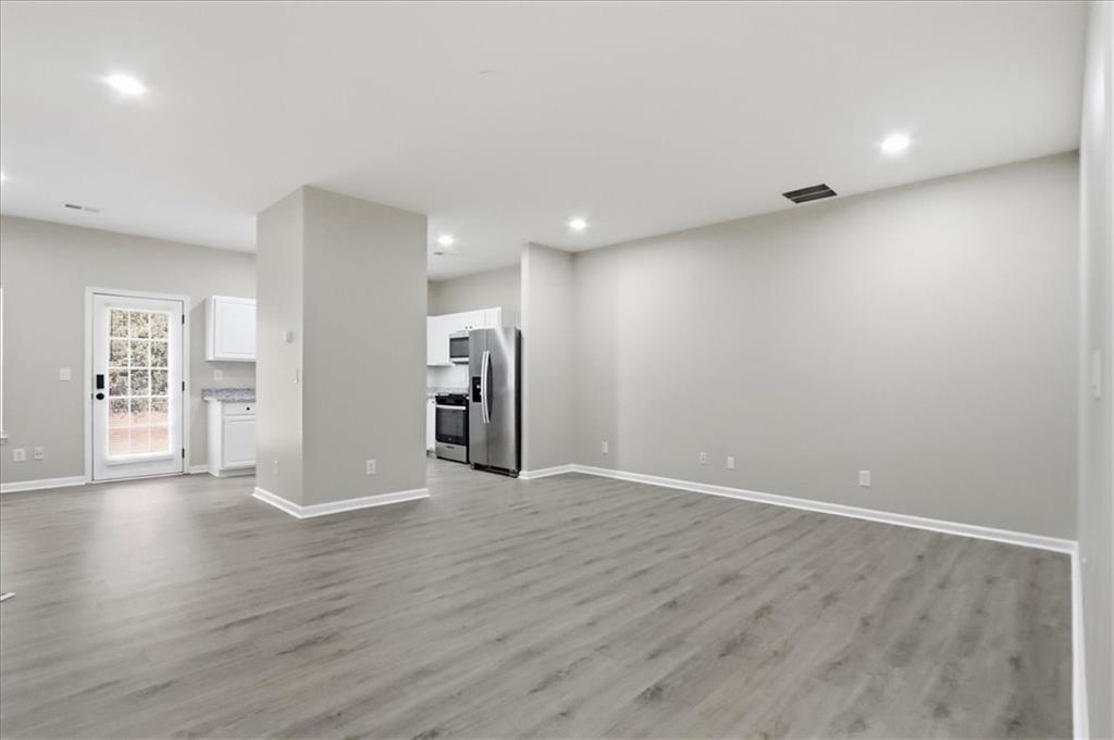 5630 Lawley Road Alpharetta, GA 30022 - Photo 11 of 65 a view of an empty room with wooden floor