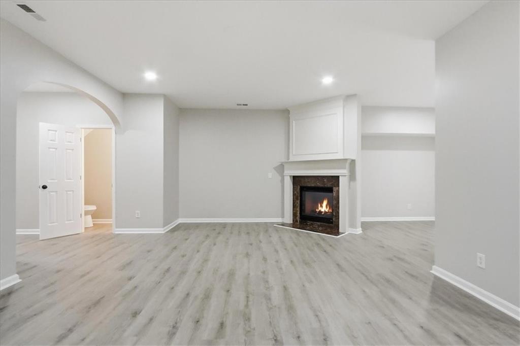 5630 Lawley Road Alpharetta, GA 30022 - Photo 13 of 65 a view of an empty room with a fireplace and a window