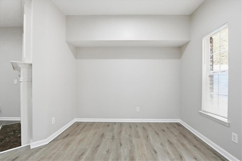 5630 Lawley Road Alpharetta, GA 30022 - Photo 16 of 65 a view of an empty room with wooden floor and a window