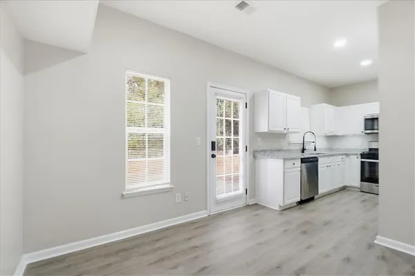 a kitchen with a refrigerator a sink and a stove top oven