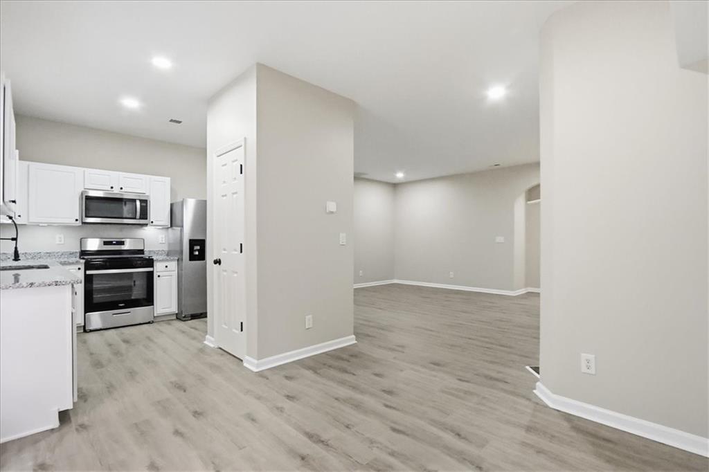 5630 Lawley Road Alpharetta, GA 30022 - Photo 18 of 65 a view of a kitchen with refrigerator stove and wooden cabinets