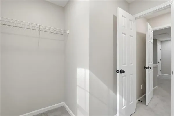 a view of a brick house with many windows and plants