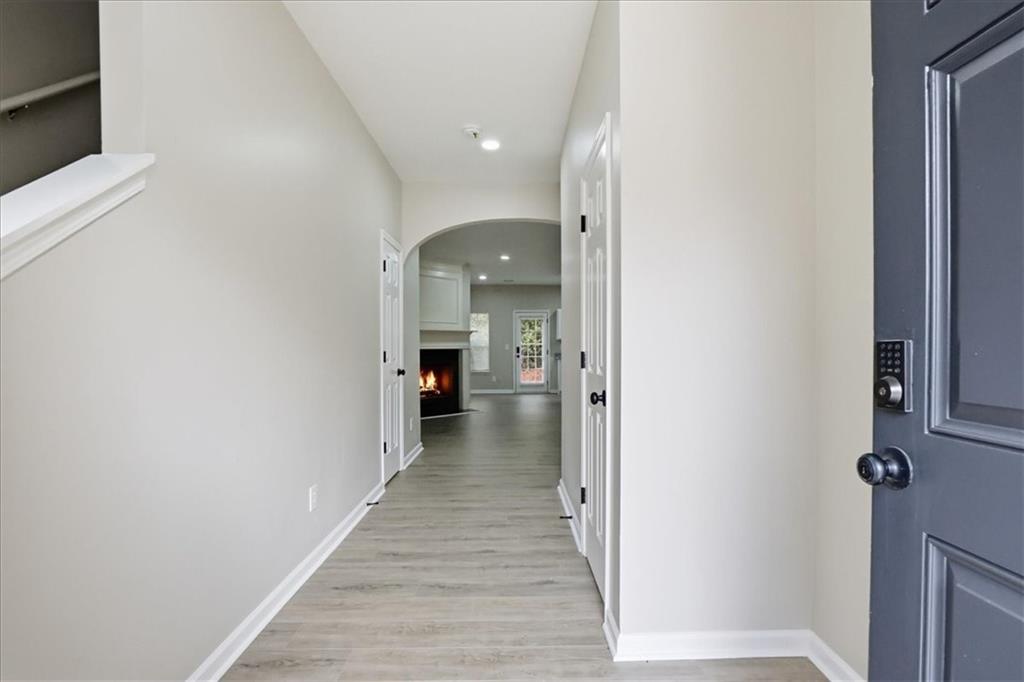 5630 Lawley Road Alpharetta, GA 30022 - Photo 5 of 65 a view of a hallway with wooden floor and staircase