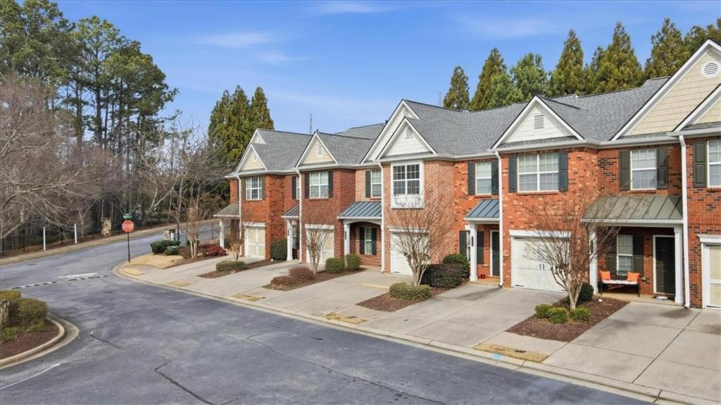 5630 Lawley Road Alpharetta, GA 30022 - Photo 57 of 65 a view of a white house with large windows next to a road