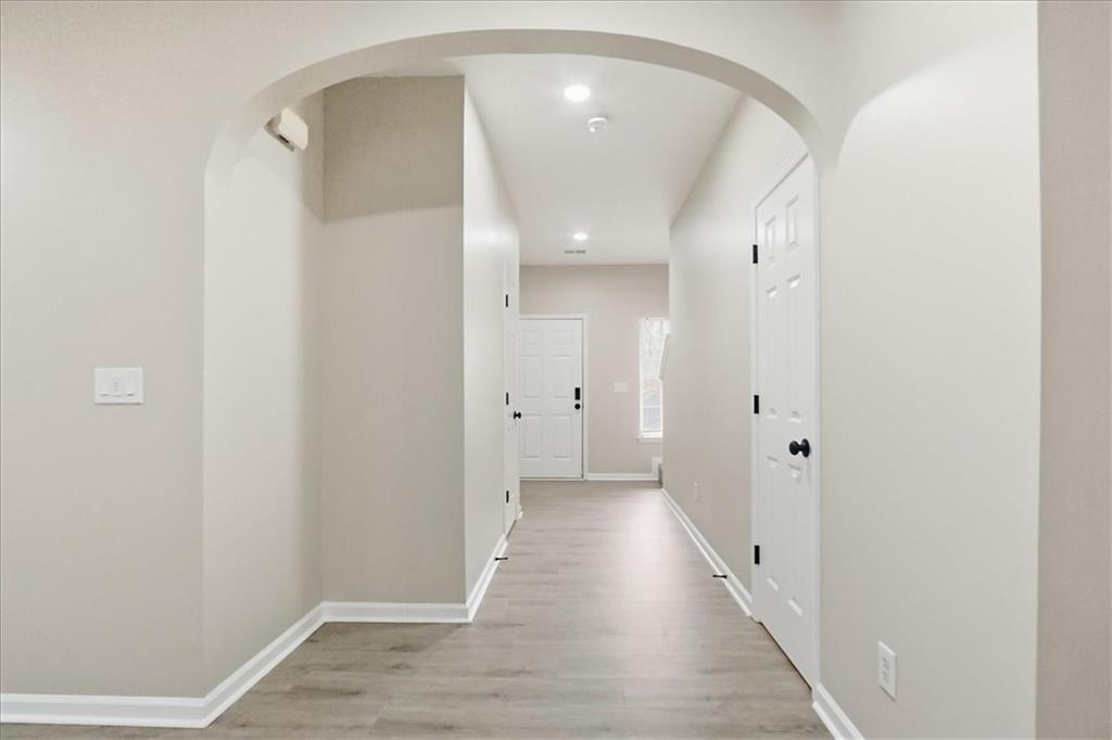5630 Lawley Road Alpharetta, GA 30022 - Photo 7 of 65 a view of a hallway with wooden floor