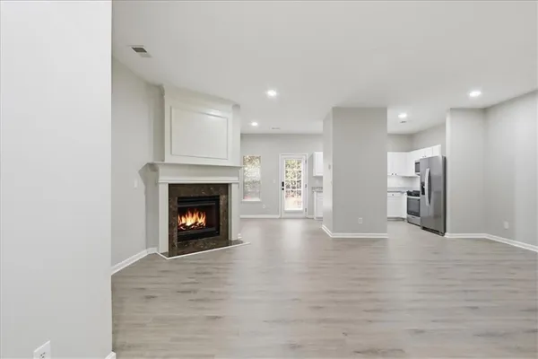 a view of an empty room with wooden floor