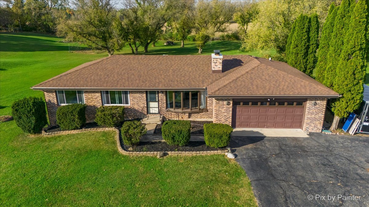 a aerial view of a house with swimming pool and garden