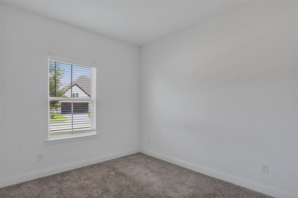 845 Ranchland Road Justin, TX 76247 - Photo 7 of 22 an empty room with a window