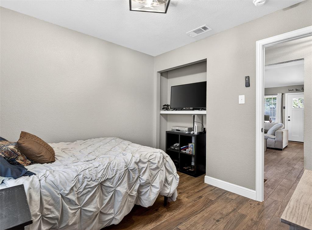 1006 Oakchase Court Azle, TX 76020 - Photo 7 of 19 a bedroom with a bed and a television