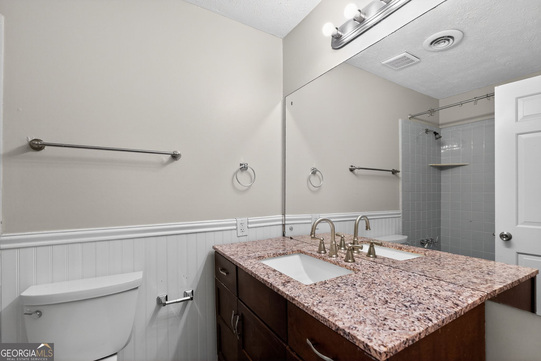 3285 Old Salem Road Southeast Conyers, GA 30013 - Photo 29 of 33 a bathroom with a granite countertop sink a toilet and shower