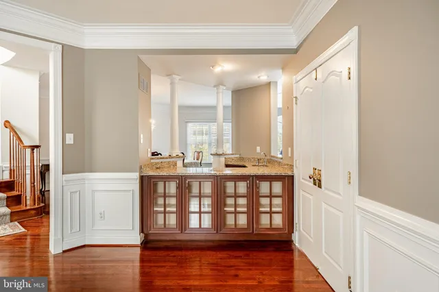 a view of a patio with a table chairs and a barbeque