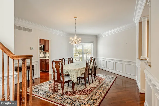 a view of a dinning table and chairs in patio of the house