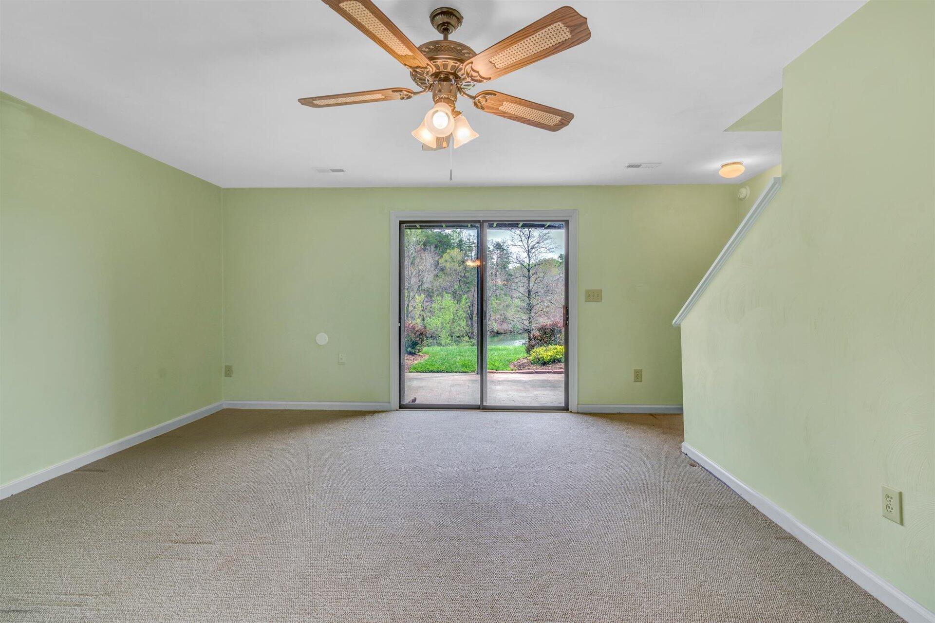 202 Harbor Ridge Drive Goodview, VA 24095 - Photo 20 of 30 an empty room with windows and fan