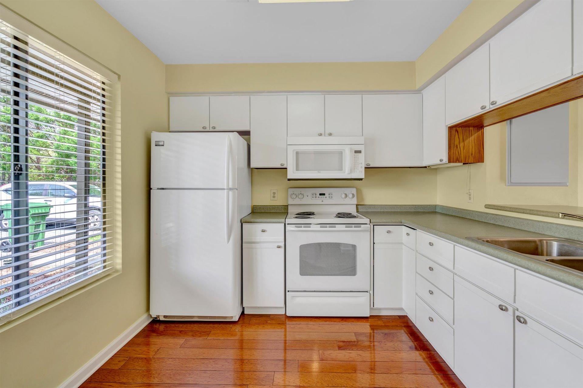202 Harbor Ridge Drive Goodview, VA 24095 - Photo 4 of 30 a kitchen with a refrigerator sink and cabinets