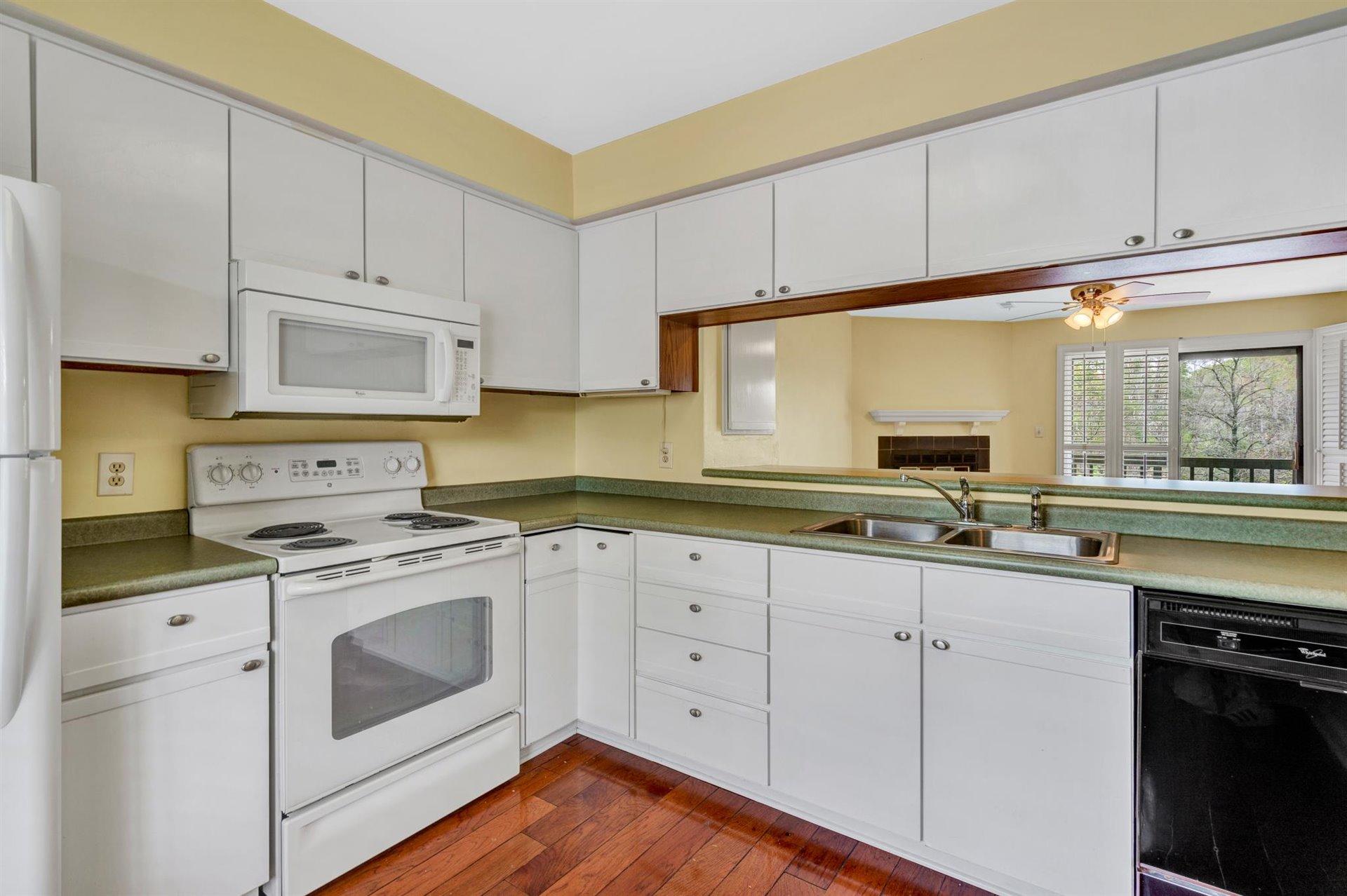 202 Harbor Ridge Drive Goodview, VA 24095 - Photo 5 of 30 a kitchen with cabinets appliances a sink and a window